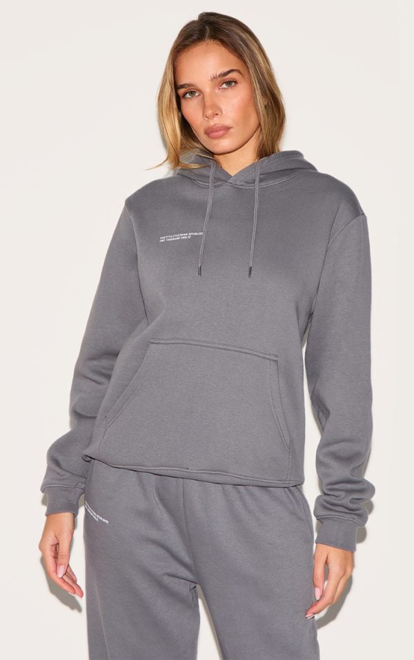 012ae95e4c87a11dd9378b14b5a4089fb295fc59_CNE5364_1_prettylittlething_logo_charcoal_grey_est_2012_oversized_fit_hoodie