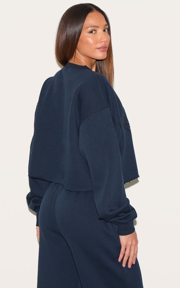 0c4d85b42307b37ebcc797c89ba0ae50c120a2da_CNM2679_2_tall_navy_distressed_detail_varsity_cropped_sweatshirt