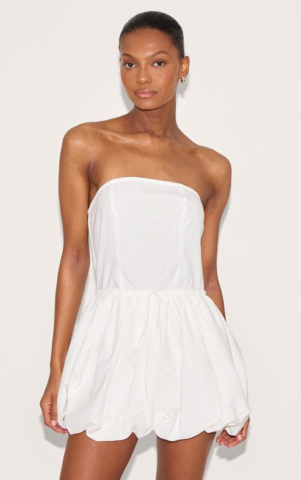0e146a51e736a8bb666d1cd4d72422d632293f38_CNL8932_1_white_linen_bandeau_tie_waist_puffball_dress-1