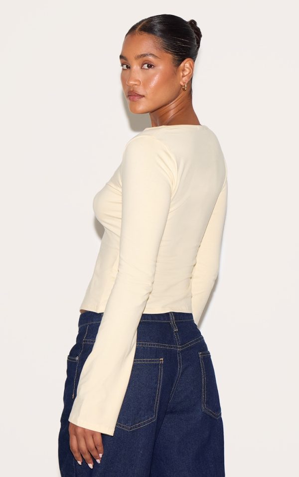 10350144d66fd2121b7bbf4d0c1a0c968e3ef34c_CNM6354_2_almond_asymmetric_button_down_detail_long_sleeve_top