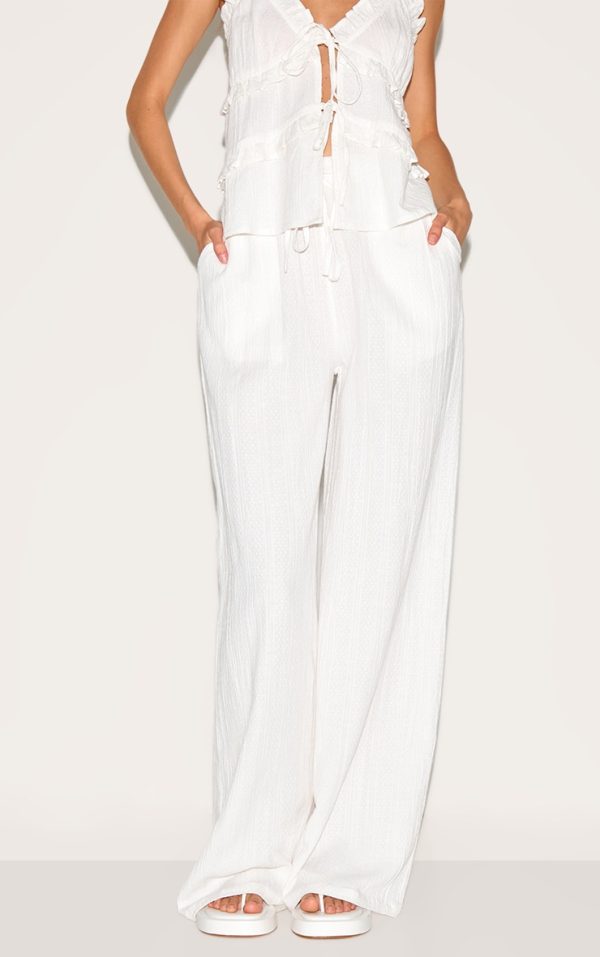 12e7865016ba19ff919e4be0f153bb553dfa5857_CNM3210_2_white_textured_mid_rise_wide_leg_trousers