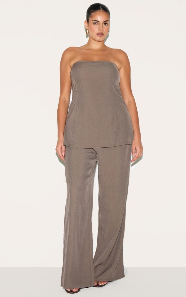 179c930a17ac5c8dc82b09ff8b90d6626d3bf9eb_CNM2025_1_plus_taupe_woven_tailored_longline_bandeau_flared_jumpsuit