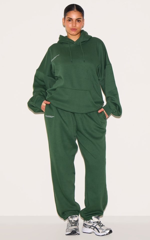 1fefecf4118a3225fe2a0c00c3259d0fdee5d11a_CNG1365_1_prettylittlething_plus_forest_green_est_2012_printed_joggers