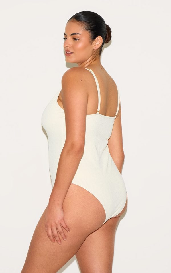 255cf85b6f951fcdf38b796832cbeee0c626765f_CNM4875_2_plus_cream_textured_flower_trim_plunge_swimsuit