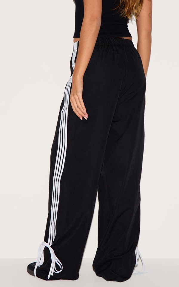34838acfce006ed73f04175b1ab43a52a03b9168_CNI1148_3_black_shell_bow_detail_track_pants