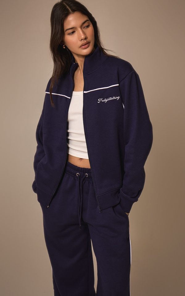 504de18e43287a0dc63f4446d00f7753d5823dfc_CNM4825_4_prettylittlething_dark_blue_contrast_piping_detail_zip_through_track_top