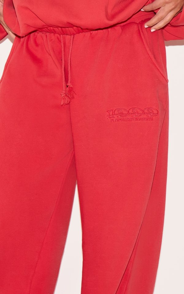5120414e08bdf9a7a6036bd3d821946750b7441b_CNM6347_4_plus_red_prettylittlething_red_embroidered_straight_leg_joggers