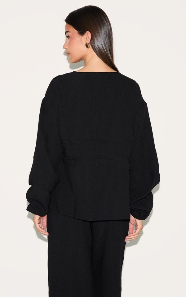 5347d8db3f52e07414ad6824d7b9d3357b9127cc_CNM2109_2_black_ruched_side_long_sleeve_plunge_top