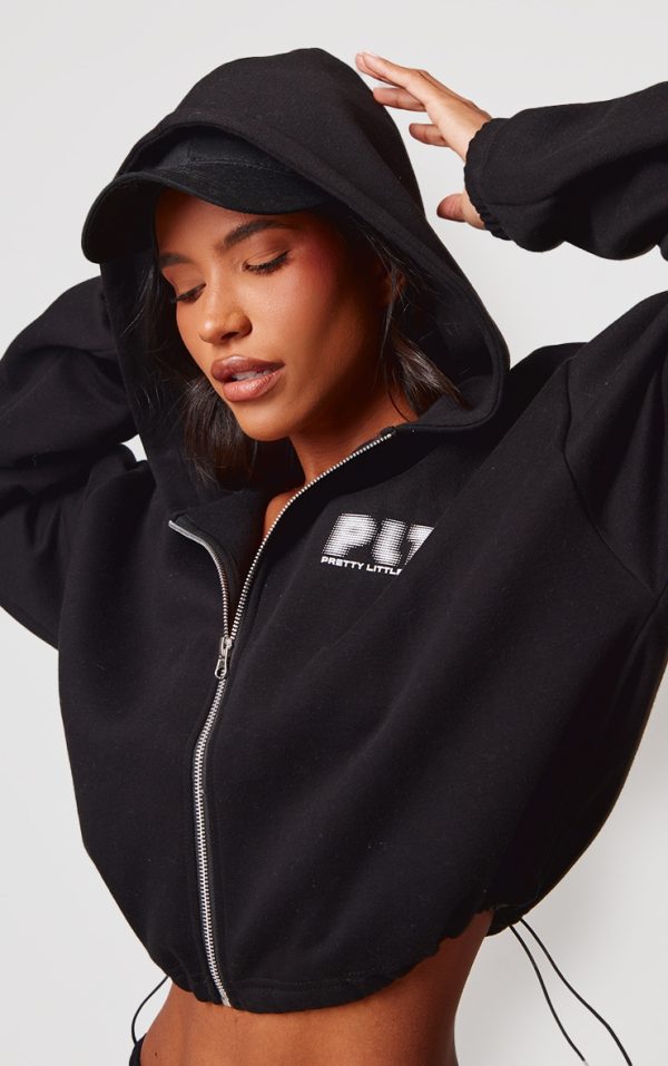 5b86691001fd4e17de9122e8e933da3d92a8a85e_CNK1544_1_prettylittlething_black_elasticated_hem_zip_up_hoodie