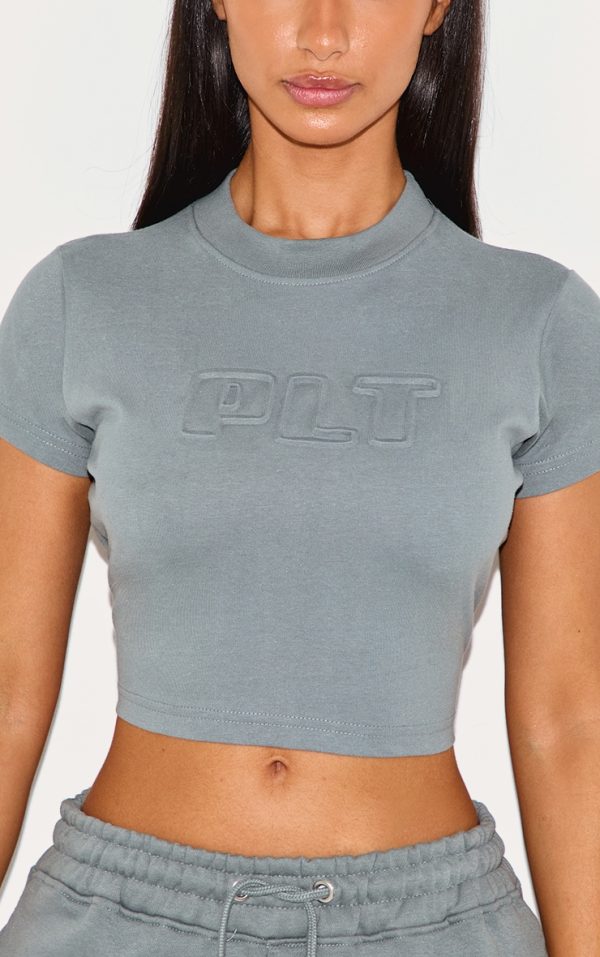 6023195f04992fe7b1cf2f07c933badbbfb23706_CNK0427_4_petite_teal_plt_embossed_cropped_baby_tee