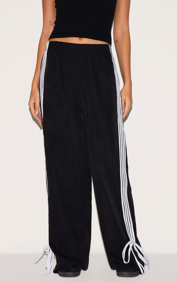 75f9e91a584d8b125ff85f5450058fef099fd688_CNI1148_2_black_shell_bow_detail_track_pants