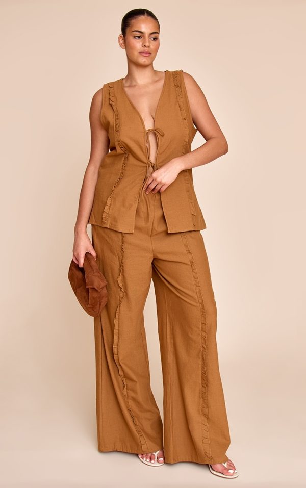 80f27be1ea410c607a36bab29d74f7870b952abd_CNM5050_3_plus_tan_sleeveless_tie_front_top