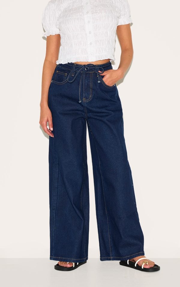 81df9a5296aeb11f4135ecc04031d8a025bd0fca_CNL9153_1_petite_dark_indigo_wide_leg_jean_with_adjustable_waist_tie