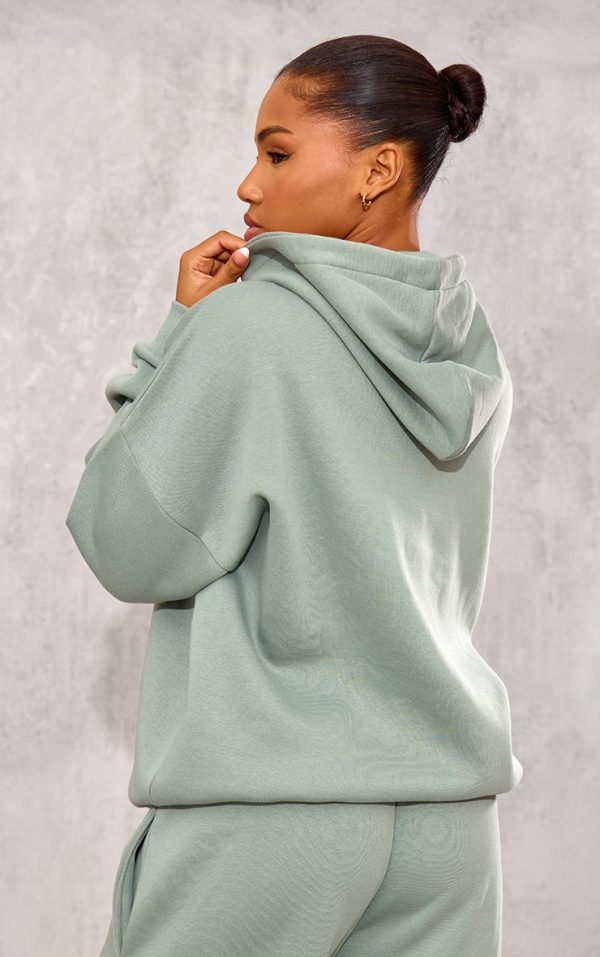 8420c6e2d86804bbf30ed476086bb72ad1266eb1_CNK1766_2_prettylittlething_sage_athletics_club_embossed_graphic_oversized_hoodie