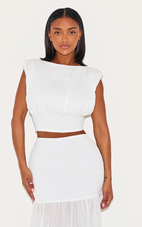 8603fb6aef246f41962a350b673d08c1754700d0_CNM6273_1_shape_cream_boat_neck_shirred_cinched_waist_top
