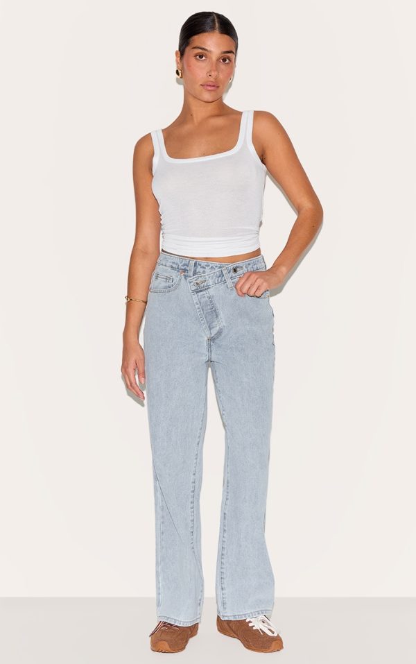 8819a6c861aeb7927e566ed4442fc852a658fd4b_CNM1834_1_petite_light_blue_denim_asymmetric_waistband_straight_leg_jeans