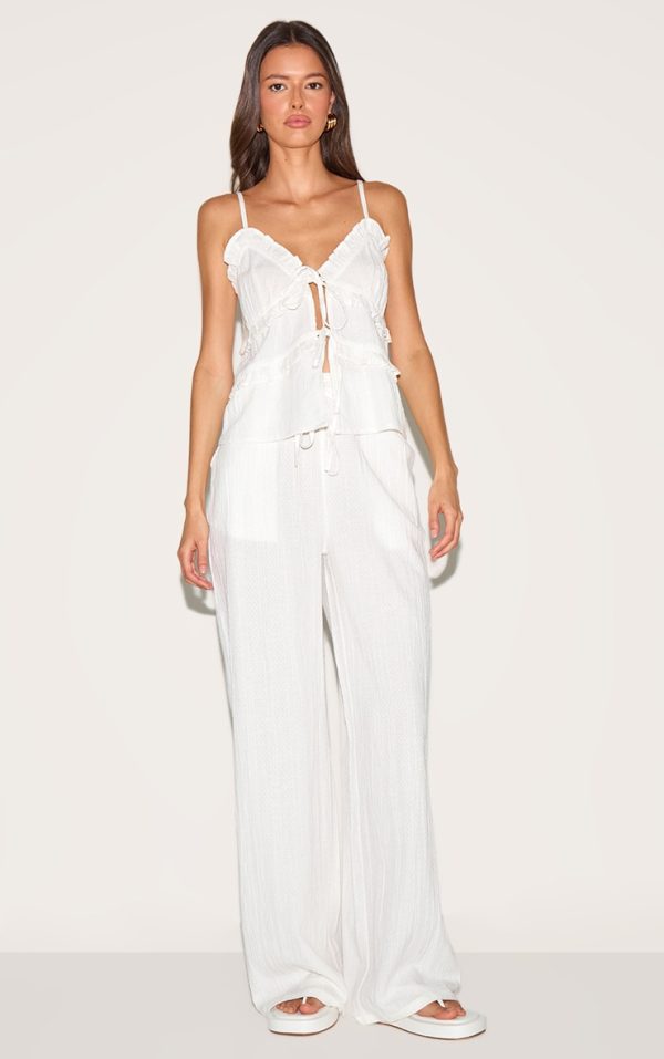 8a8c29acf7c9f115f8cfd2b9d1afcef434649562_CNM3210_1_white_textured_mid_rise_wide_leg_trousers