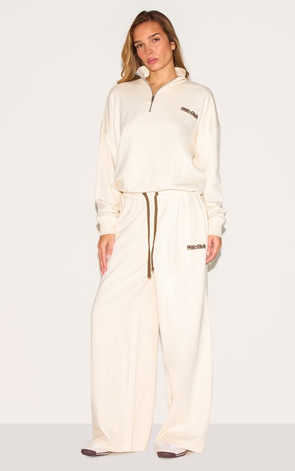 8c579f25f84adb08c35bab95ec4247d58e3c4b06_CNM4682_3_cream_run_club_puff_print_quarter_zip_sweatshirt