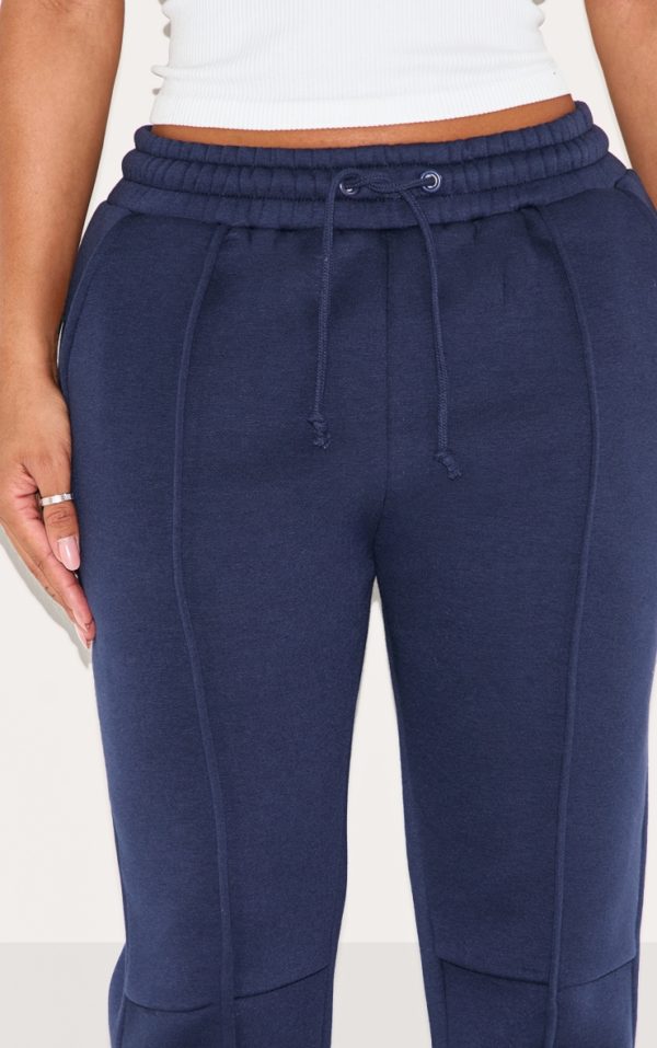 980f0d7664b72fda26fa4f655b2b2eb74be94b14_CNM0018_4_shape_navy_highwaisted_pintuck_flared_joggers