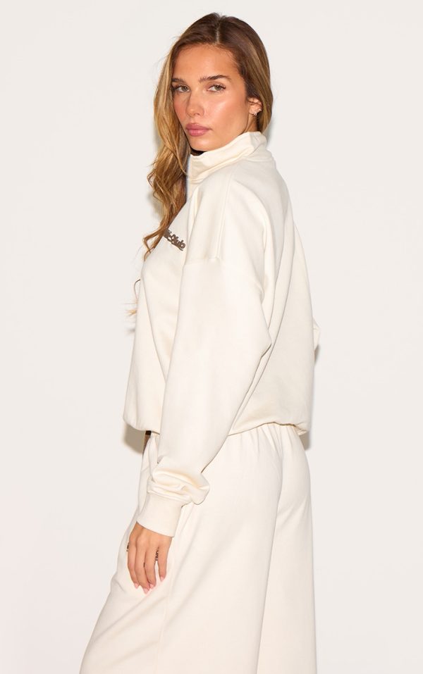 98c3f705cdc200a4d58743e898ec4496c03cc7db_CNM4682_2_cream_run_club_puff_print_quarter_zip_sweatshirt