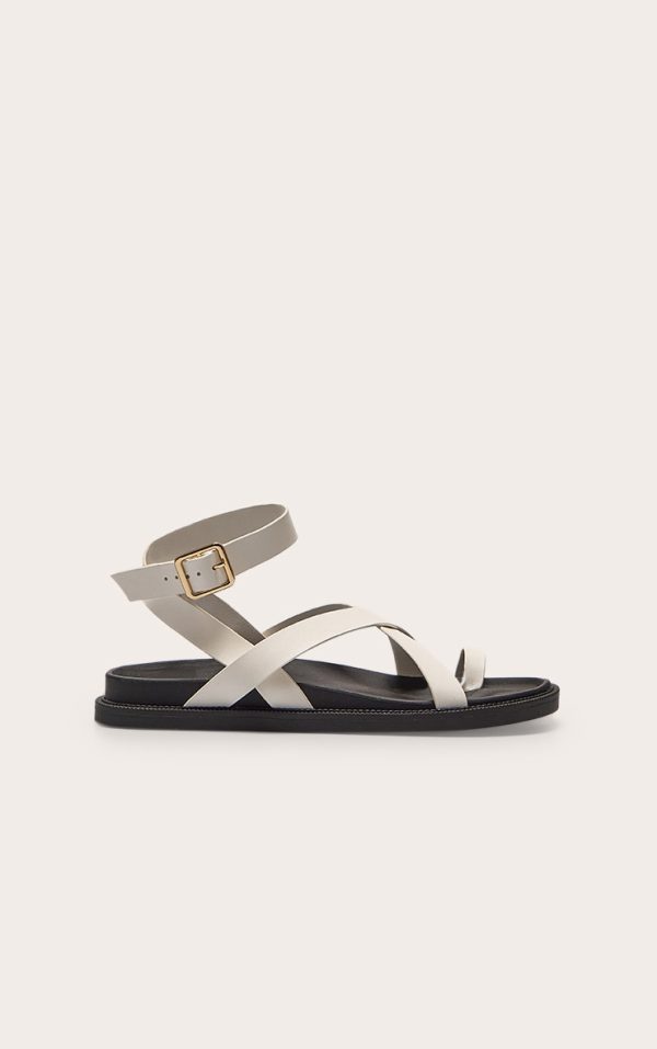9aab16499d6df4dbbb21c291b554e7a666ebb0fc_CNL6799_1_cream_pu_round_toe_gold_toe_loop_strappy_footbed_sandals