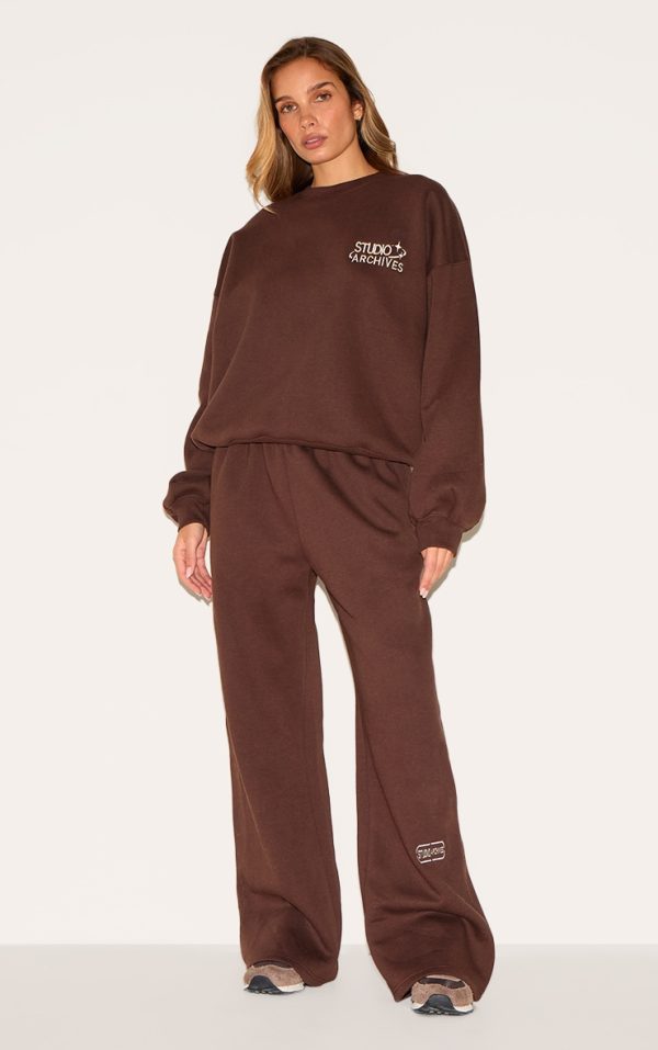 a5449ccb386749db452b68b50b71e00d2faae6f6_CNM4805_1_chocolate_studio_archives_embroidered_thin_waistband_drop_crotch_joggers