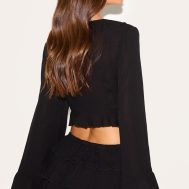 ad8cd1c6b912ef70433facbabd0e6150caceded5_CNM3228_2_black_cheesecloth_ruffle_tie_front_long_sleeve_top