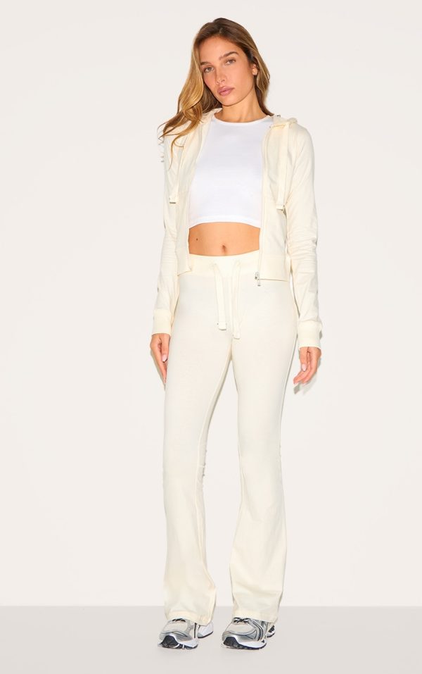 b0692b8cc416cd41e1088e40a1e987f99d0226e3_CNM0344_1_cream_low_rise_skinny_flare_trousers