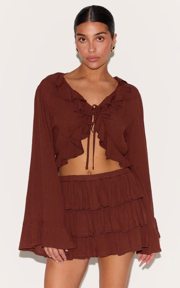 c025ca930abebf0fe5bee0eefb695d3993d6d6cf_CNM3968_1_petite_chocolate_cheesecloth_ruffle_tie_front_long_sleeve_top