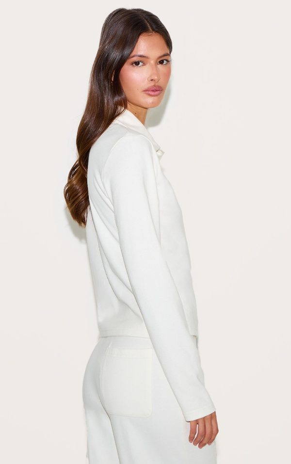 c575d8184450b438198a574e9c83b9c1431fd7f3_CNM6186_2_cream_long_sleeved_super_soft_v_neck_button_up_top
