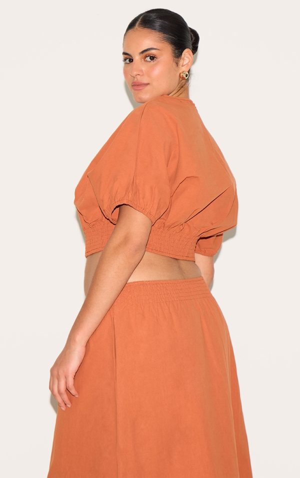 c6fe5986a38b71c91b48a16805773a93eeae081e_CNM3422_2_plus_burnt_orange_sheered_waist_cap_sleeve_crop_top