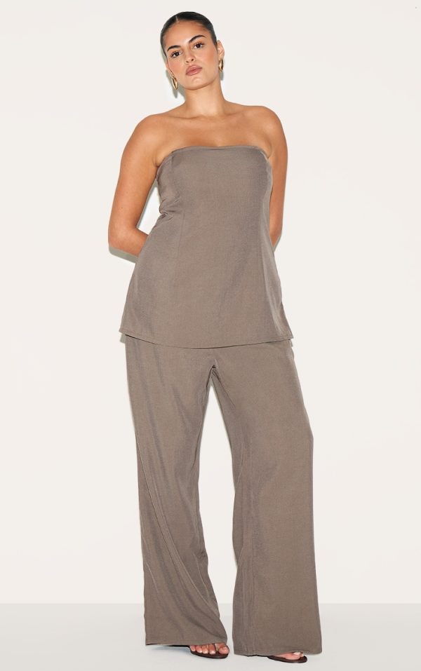 ce4e036944f4b3aa19aa7e00428ea313f77ae3b7_CNM2025_3_plus_taupe_woven_tailored_longline_bandeau_flared_jumpsuit