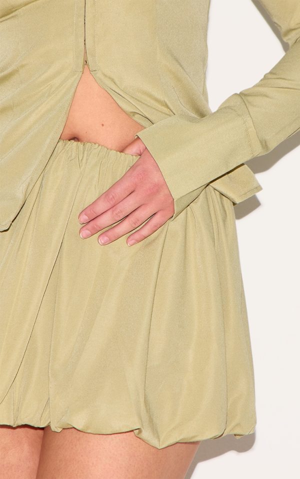 e70fe2e7eada745a159899999bb86b804bc0481f_CNM1019_5_shape_olive_tailored_puff_ball_mini_skirt