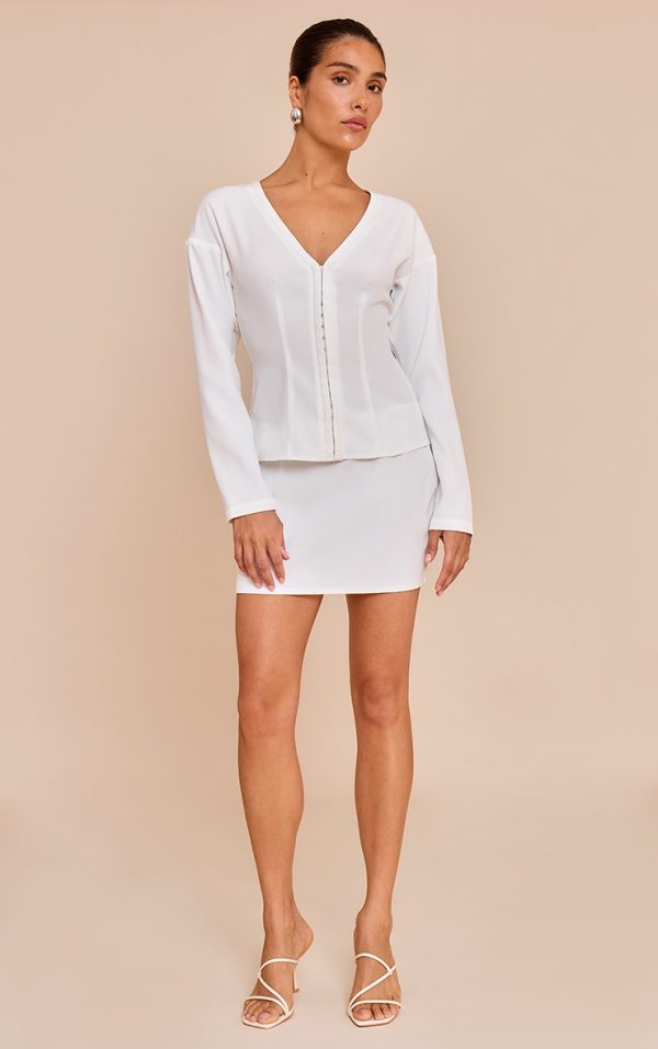 f903732f6febf2146e8acd8eb451bc53f0418df8_CNM7002_4_petite_white_mid_rise_mini_skirt