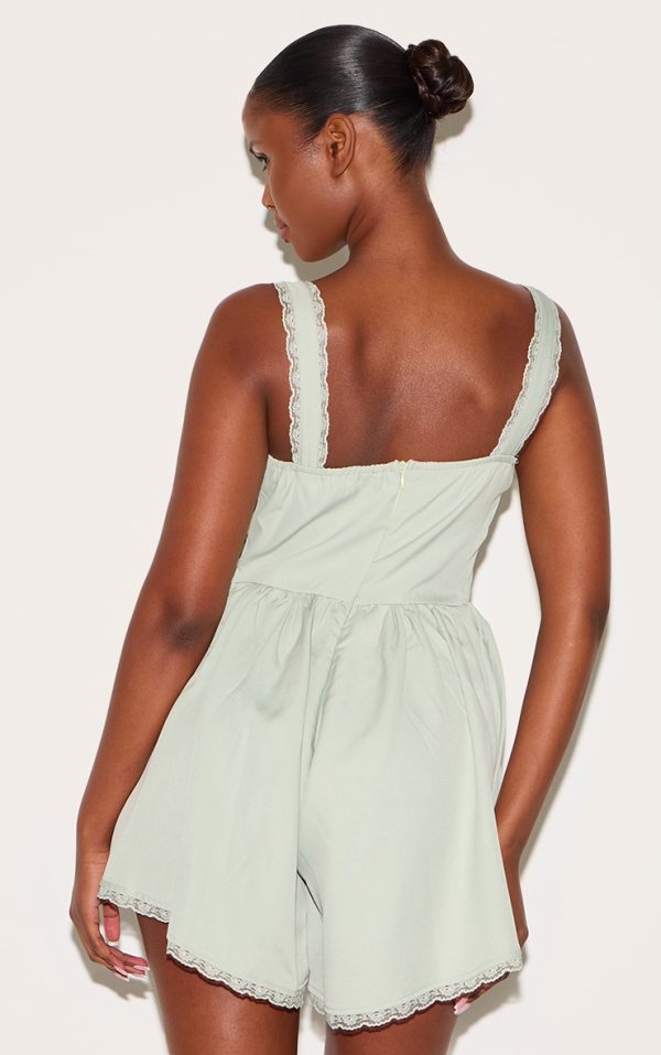 fe8ac42b1658a5ec768a9a6d525b606066e9f12b_CNM0010_2_sage_green_woven_lace_detail_strappy_playsuit-1