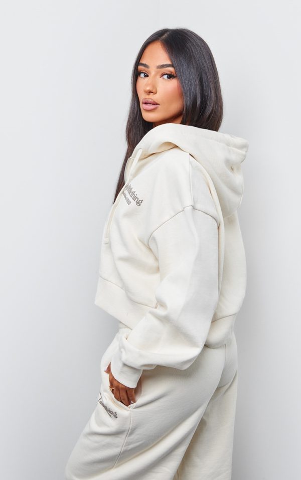 fec8c0a514804d8f5577441314519a9e11724312_CNK1317_2_prettylittlething_petite_cream_premium_print_zip_front_hoodie