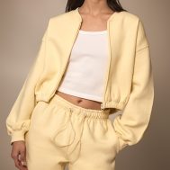 fed66d7b4be6a7e37ca62387fc1e6afb98af4e30_CNM9984_1_butter_cream_drawcord_waist_cropped_zip_up_sweatshirt