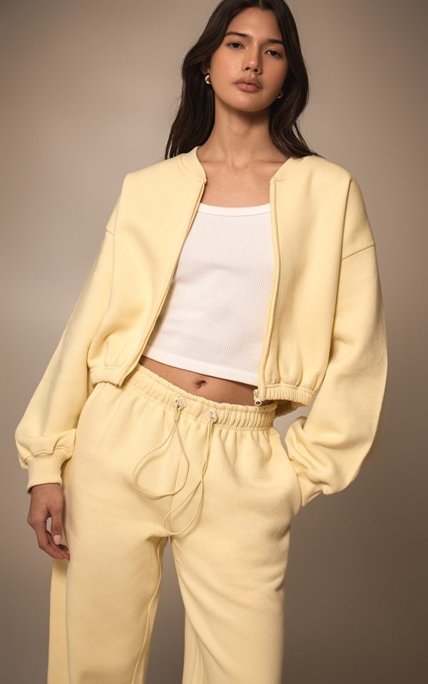 fed66d7b4be6a7e37ca62387fc1e6afb98af4e30_CNM9984_1_butter_cream_drawcord_waist_cropped_zip_up_sweatshirt